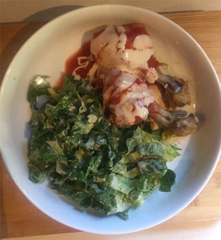 photo of chicken with blue cheese dressing and caesar salad.