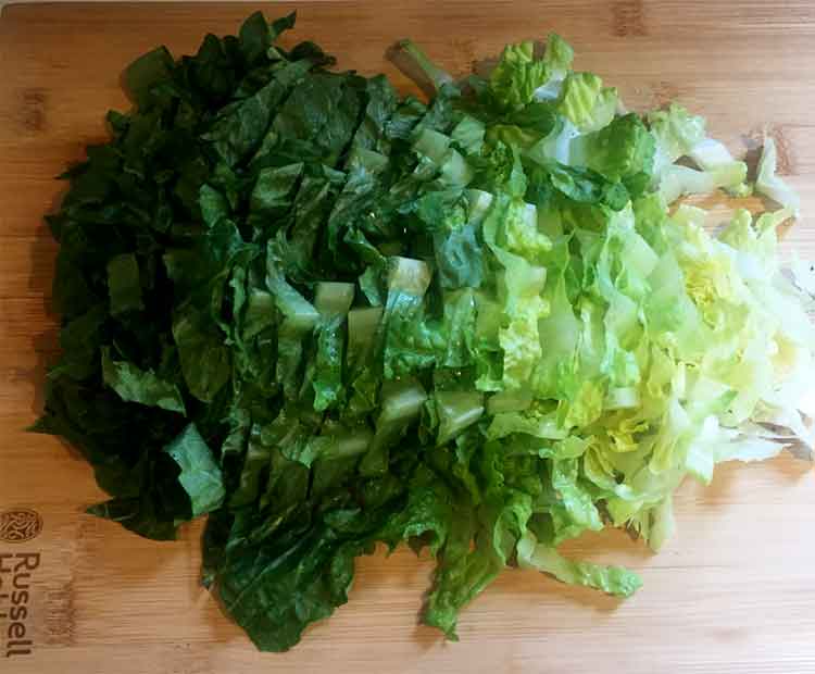 photo of lettuce chopped up on a board.