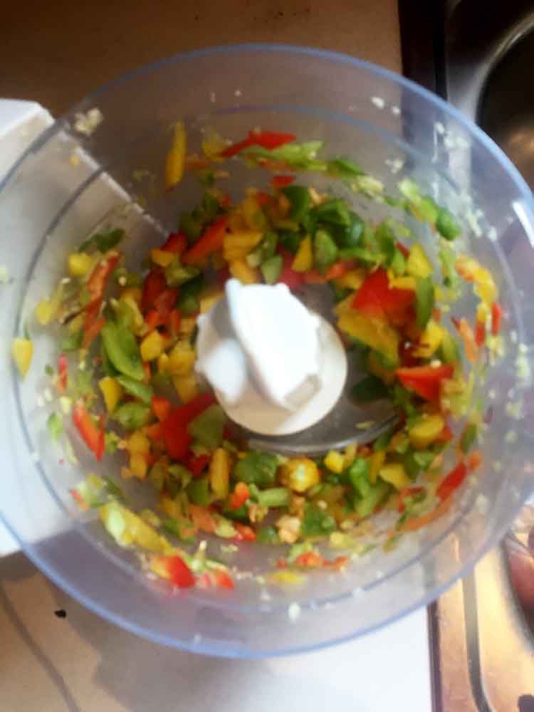 photo of peppers cut up in a food processor:KETO-CAULIFLOWER-EGG- FRIED- RICE